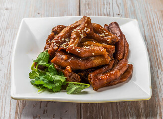 Braised Duck Feet with savory sauce, sesame seeds and cilantro served in plate on Wood Table Close up Side view of Hong Kong food