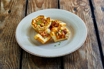 cornbread cups stuffed with ground beef, melted cheese, and green onions
