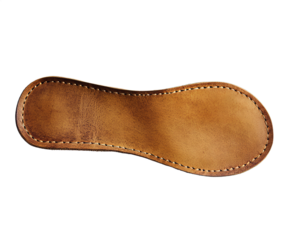 A close-up view of a handcrafted leather insole reveals its smooth surface and neat stitching, highlighting the quality of materials used. Perfect for ensuring comfort in footwear design