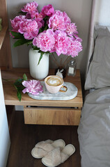 Cup with cappuccino, flowers peony, morning concept, woman's day