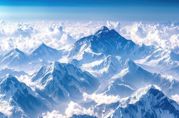 Obraz premium Snow-capped mountains contrast beautifully with the deep blue sky and white clouds