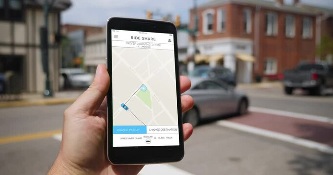 A man standing on a small town street corner holds a smartphone showing a ridesharing app as his driver arrives. Pittsburgh suburbs. Fictional interface.  	