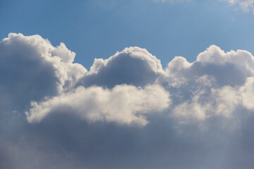 Fluffy clouds appear weightless against the backdrop of clear blue sky. Symbolizes inspiration and lightness.