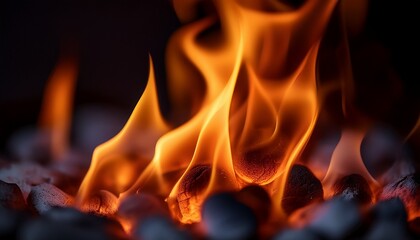 Macro view of a burning flame; a close up view of a fire burning; up and close view of a bonfire burning in a wood pit crackling and amber flying; orange and yellow flame is burning in a fire pit; 