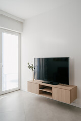 Modern living room featuring a large LCD television and minimalistic design elements