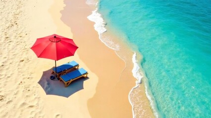 Sun loungers and umbrella on sandy beach top view