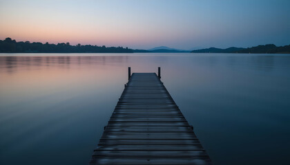Naklejka premium Serene lake pier at sunset perfect for relaxation meditation and travel advertising campaigns