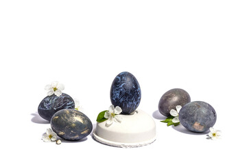 Easter egg on a beton stand isolated on white background. Traditional symbol, blooming cherry