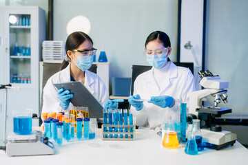 Scientist team meeting and writing analysis results in the laboratory study