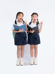 Fototapeta premium Two enthusiastic students sharing insights, dressed in school uniforms, ready to learn and pointing up