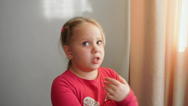 Young girl raising hands, speaking confidently, expressing refusal. Child showing determination, defending her point, passionately rejecting idea. Close-up of assertive facial expression,body language