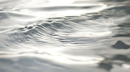 Light abstract white background with a subtle rippled texture, creating a sense of fluidity.