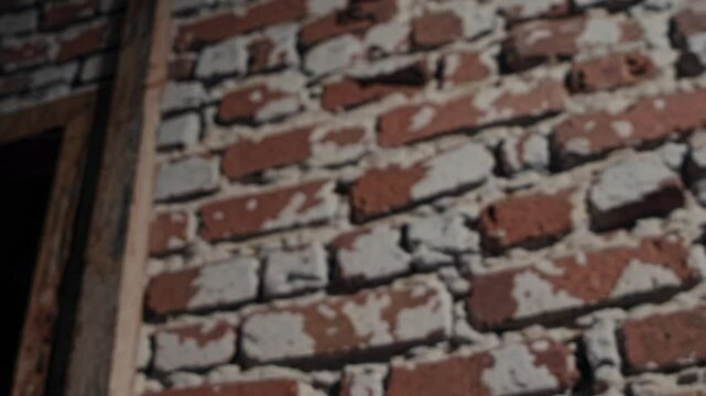 Close-up Perspective of a Red Boxing Glove Against a Textured Brick Wall, Highlighting the Material, Color, and Athletic Context of Boxing Training or Sports Equipment