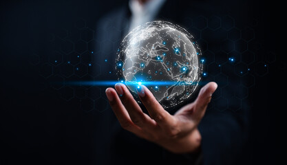 A person holds a glowing, digital globe, symbolizing technology, connectivity, and a global...