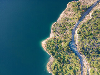 Aerial View of a Scenic Mountain Road Alongside a Lake, Wallpaper Background
