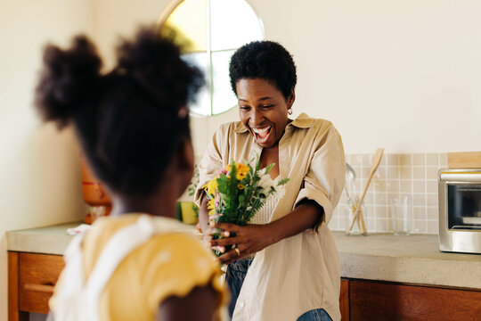 Mother and daughter sharing a special moment with a flower surprise