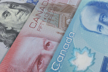 Canadian dollar and US dollar banknotes. Cash. Financial concept.