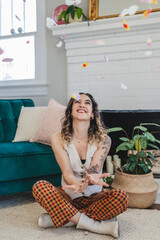 Woman throwing flowers in the air like confetti