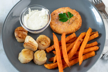 salmon burger with scallops and sweet potato fries,
