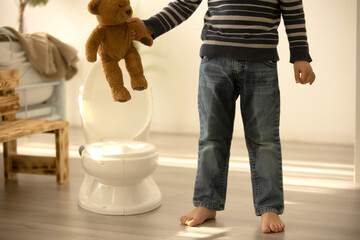Little toddler child, boy,  pee in his pants while playing with toys, child distracted and forget...
