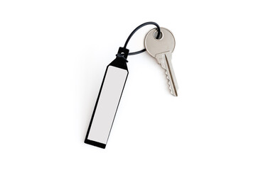The key and keychain are made of plastic with a place for inscriptions on a white background. The concept of real estate transactions.