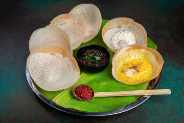 Traditional Sri Lankan Hoppers 
Experience authentic Sri Lankan cuisine with this dish featuring plain and egg hoppers, with Onion Chutney and dry red chili Sambol