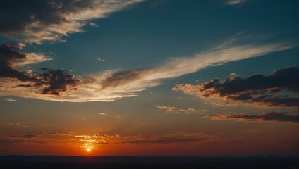 Fototapeta premium Dramatic sunset sky with colorful clouds and golden light, silhouetted horizon