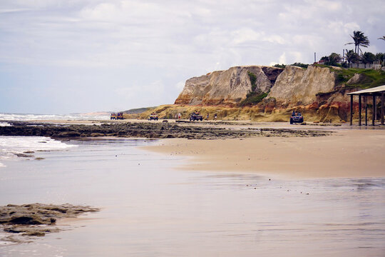 Colorful natural sandstone rocks with red, curry and beige geological lines. Morro Branco is a famous beach in Cear&aacute;, Brazil, surrounded by these colorful sand rocks that form a labyrinth.