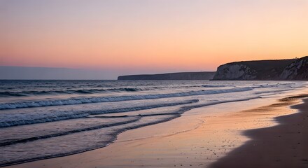 Obraz premium A peaceful beach at sunset, with soft pink and orange hues in the sky, waves gently rolling onto the sand, and a silhouette of distant cliffs, Ai Generated