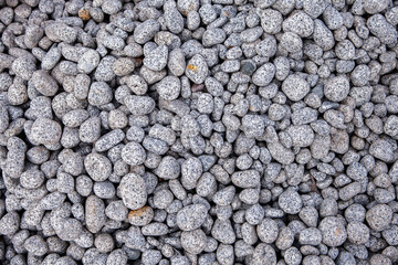 Pebbles on the ground as an abstract background. Texture. Granite 