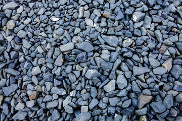Pebbles on the ground as an abstract background. Texture. Granite 