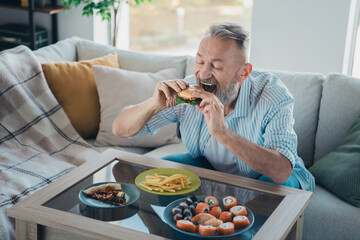 Elderly man enjoying a delicious meal in his cozy home, surrounded by comfort and light, embracing a relaxed and happy lifestyle