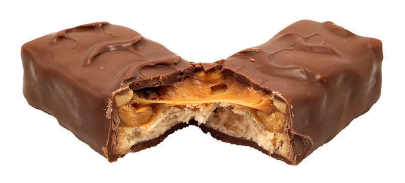 Bar with peanuts, hazelnuts, caramel and chocolate on a white background. View from above. Nut bar isolate. Sugar
