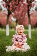 child spends time outdoors. Blooming sakura