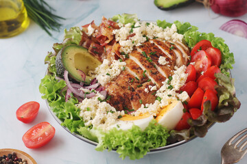A bowl with cobb salad, traditional American dish	