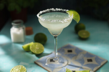 A glass with margarita cocktail with lime