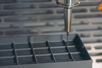 The CNC milling machine cutting the graphite electrode parts.