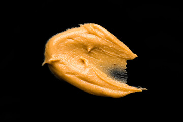 Delicious and healthy peanut butter on black background	