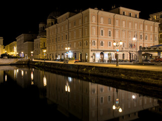 famous building detail in trieste italy after sunset at night (historic famous european travel destination in europe) border of slovenia mediterranean sea coast canal landmark dark sky