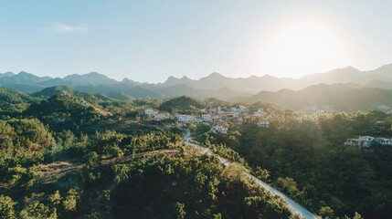 Obraz premium Sunlit mountain village scenic aerial view.