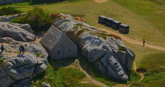 France, Meneham, 26 February 2025: Aerial view of an ancient stone house in the rocks