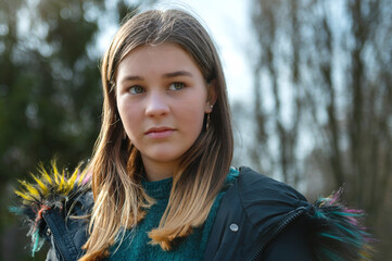 Sad teenage girl in spring park. Offended cute young girl outdoors. Upset beautiful teenage girl...
