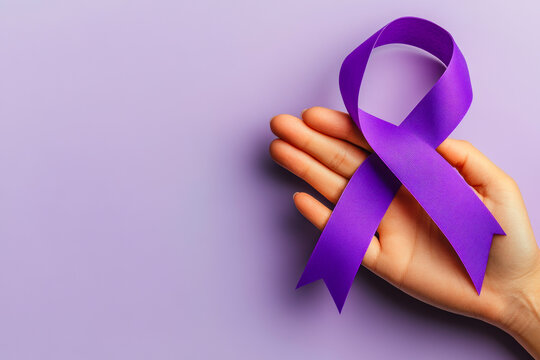A hand holds a vibrant purple awareness ribbon against a soft purple background. - Powered by Adobe