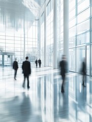 Blurred office building lobby with people walking in a modern corporate environment. Intentionally blurred background with clean minimalist design and architecture