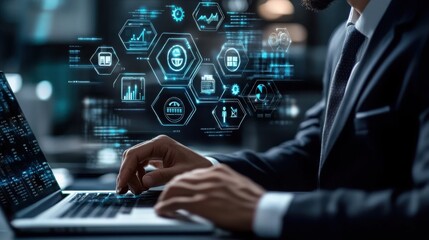 Businessman working on laptop with digital interface showing business analytics data and technology icons