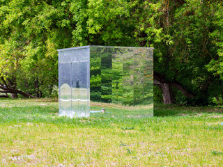 A technical structure with mirrored walls, integrated into the park landscape
