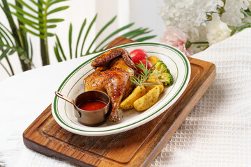 Western-style roasted chicken and side dishes on a monochrome background