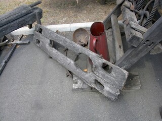 Vintage Wooden Yoke with Attached Metal Containers in Outdoor Setting