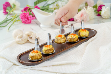 Grilled button mushrooms on a simple background