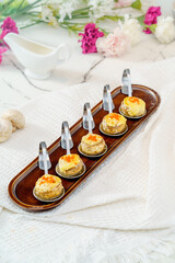 Grilled button mushrooms on a simple background